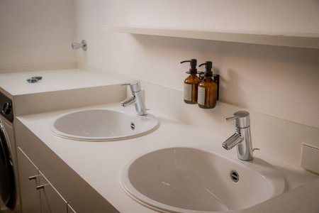 Bathroom with shower, bathtub, double washbasin, bathroom cosmetics and separate toilet