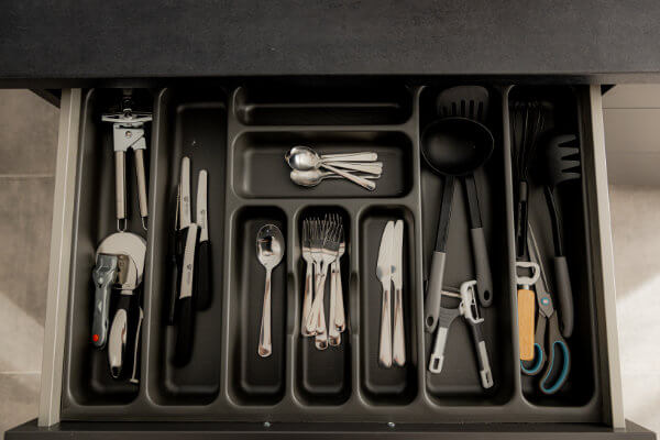 Modern fully equipped kitchen with cutlery and crockery